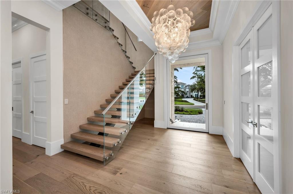 3190 Crayton Road Naples, FL 34103 - Photo 2 of 45 Impressive entrance with pivot style front door, glass stairway railing