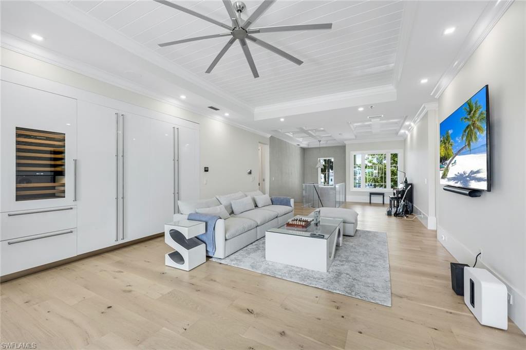 3190 Crayton Road Naples, FL 34103 - Photo 23 of 48 a living room with furniture and a flat screen tv