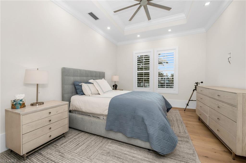 3190 Crayton Road Naples, FL 34103 - Photo 27 of 48 a bedroom with a large bed and a window