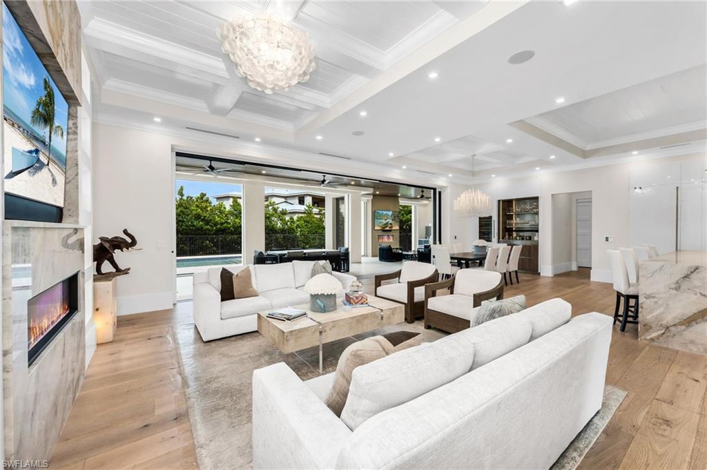 3190 Crayton Road Naples, FL 34103 - Photo 3 of 45 Spacious great room complete with dining room and wine cooler bar area! Expansive glass doors opens to the pool.