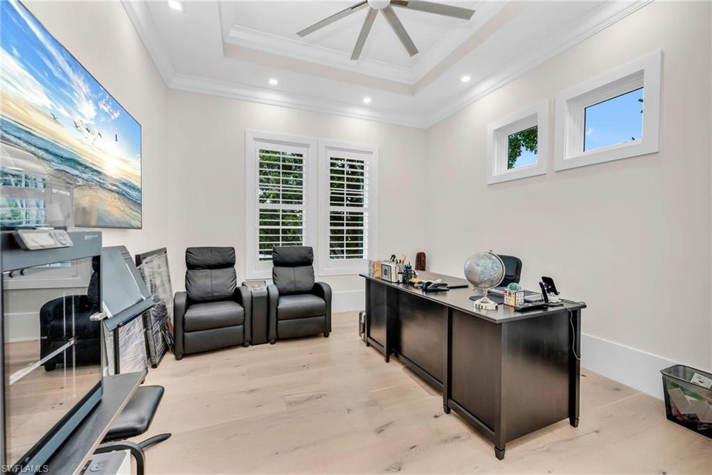 3190 Crayton Road Naples, FL 34103 - Photo 33 of 48 a living room with furniture a flat screen tv and a window