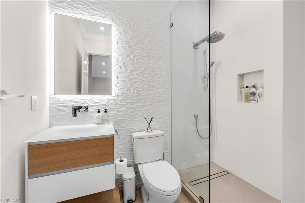 3190 Crayton Road Naples, FL 34103 - Photo 34 of 48 a bathroom with a sink a toilet and shower