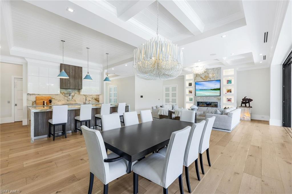 3190 Crayton Road Naples, FL 34103 - Photo 8 of 48 a view of a dining room with furniture and wooden floor