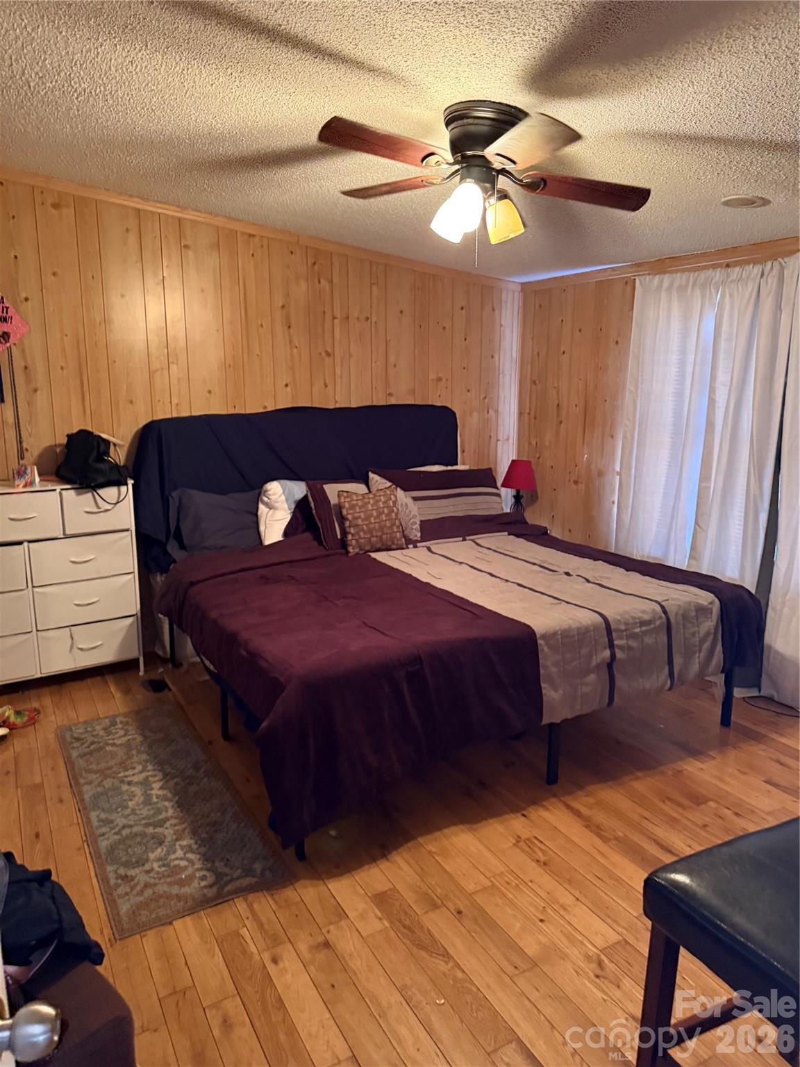 232 Fern Hill Road Troutman, NC 28166 - Photo 11 of 12 a bedroom with a bed and a chandelier