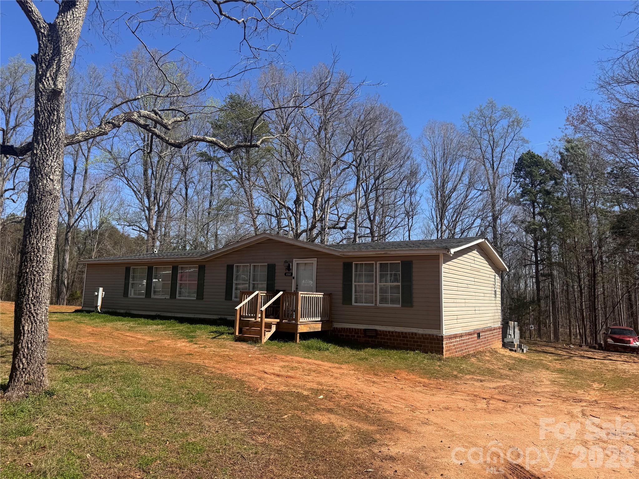 232 Fern Hill Road Troutman, NC 28166 - Photo 2 of 12 a view of a house with a yard and garage