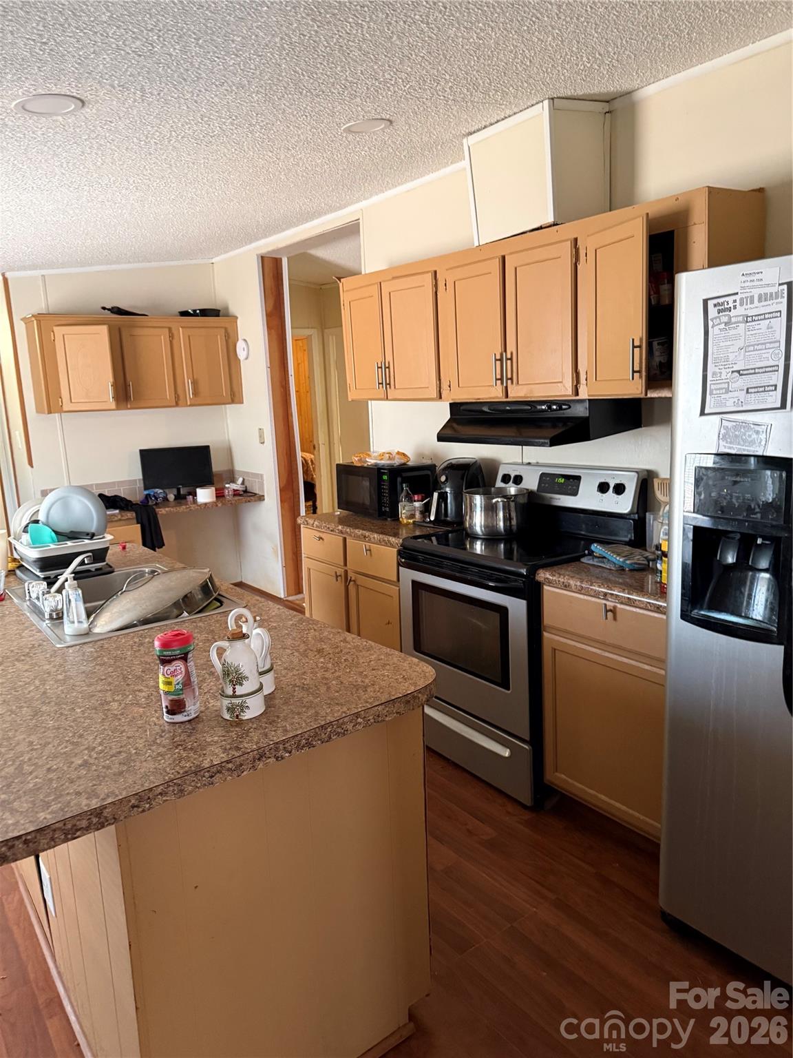 232 Fern Hill Road Troutman, NC 28166 - Photo 5 of 12 a kitchen with stainless steel appliances granite countertop a stove a sink dishwasher and a refrigerator