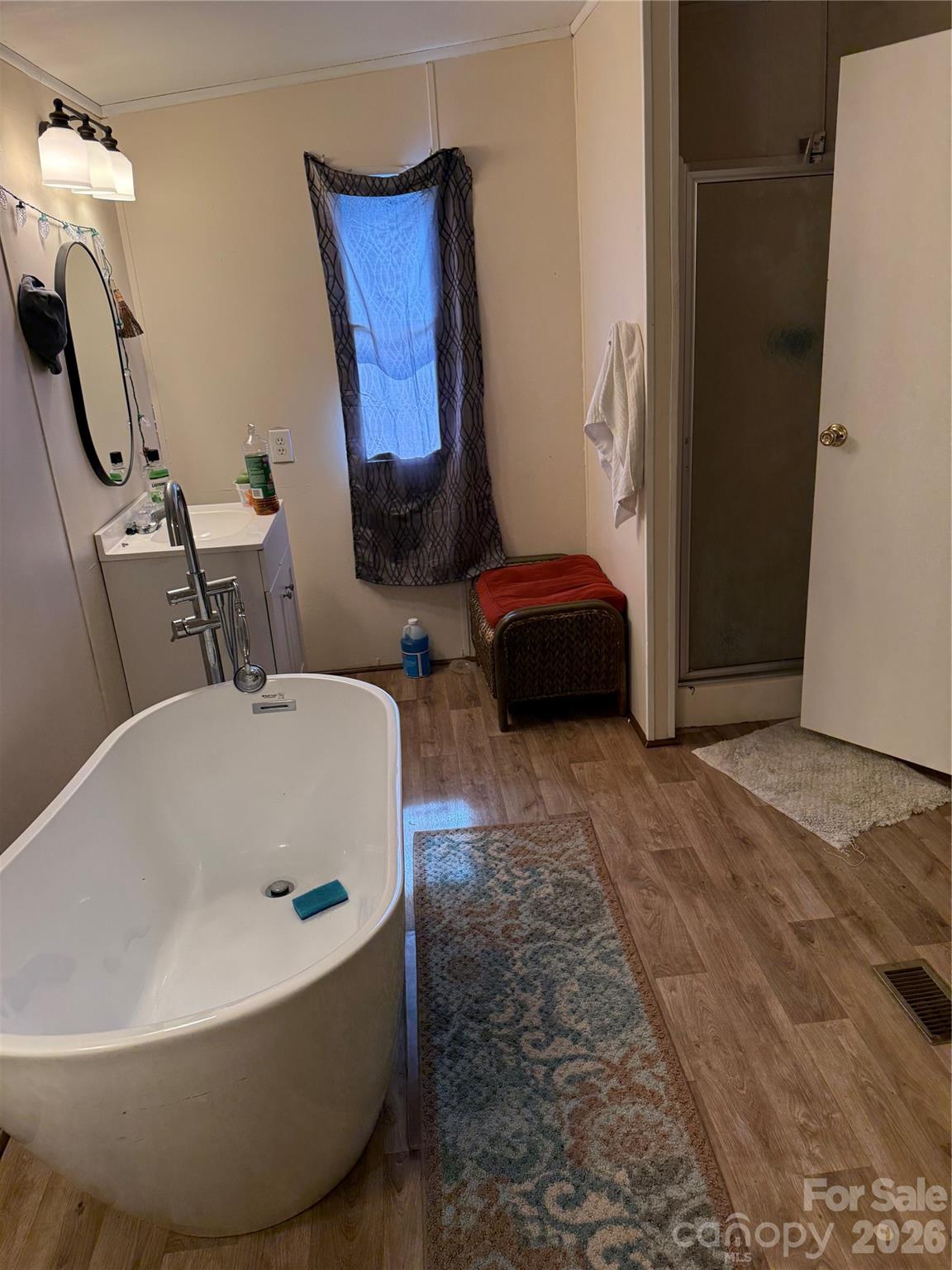 232 Fern Hill Road Troutman, NC 28166 - Photo 10 of 12 a bathroom with a tub sink and mirror