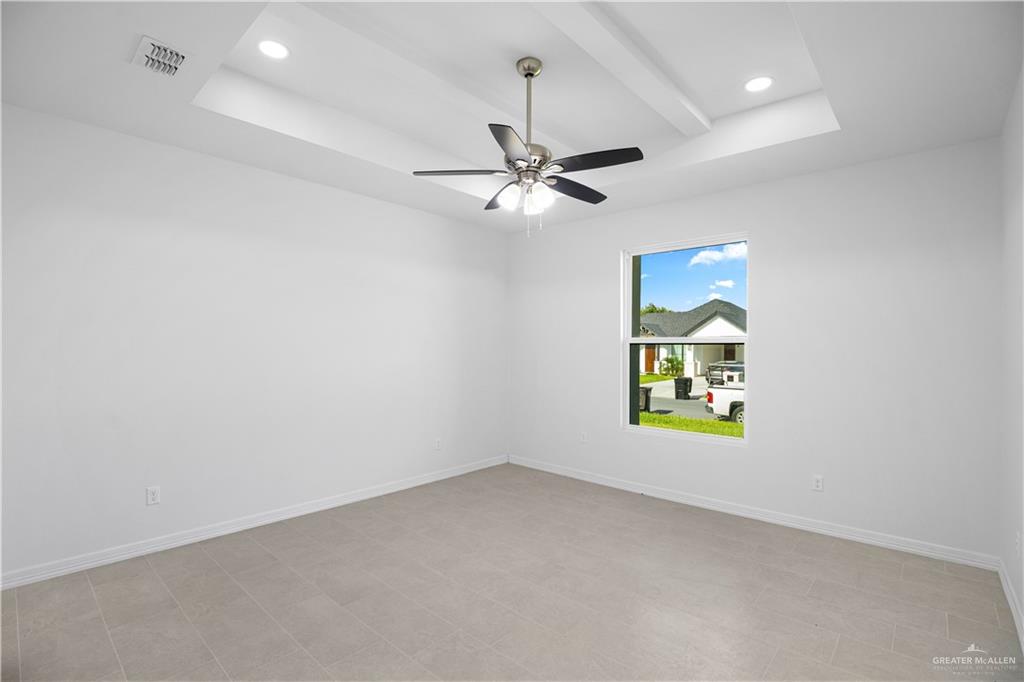 1005 Emerald Avenue Weslaco, TX 78599 - Photo 12 of 15 an empty room with a window and a fan