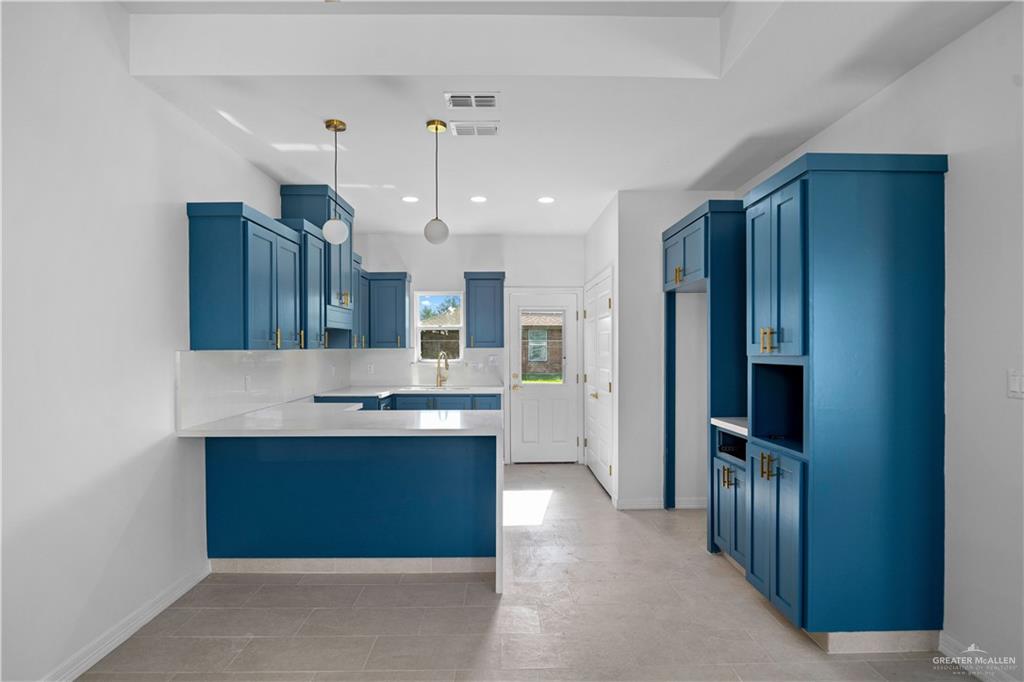 1005 Emerald Avenue Weslaco, TX 78599 - Photo 4 of 15 a kitchen with stainless steel appliances granite countertop a refrigerator and a sink