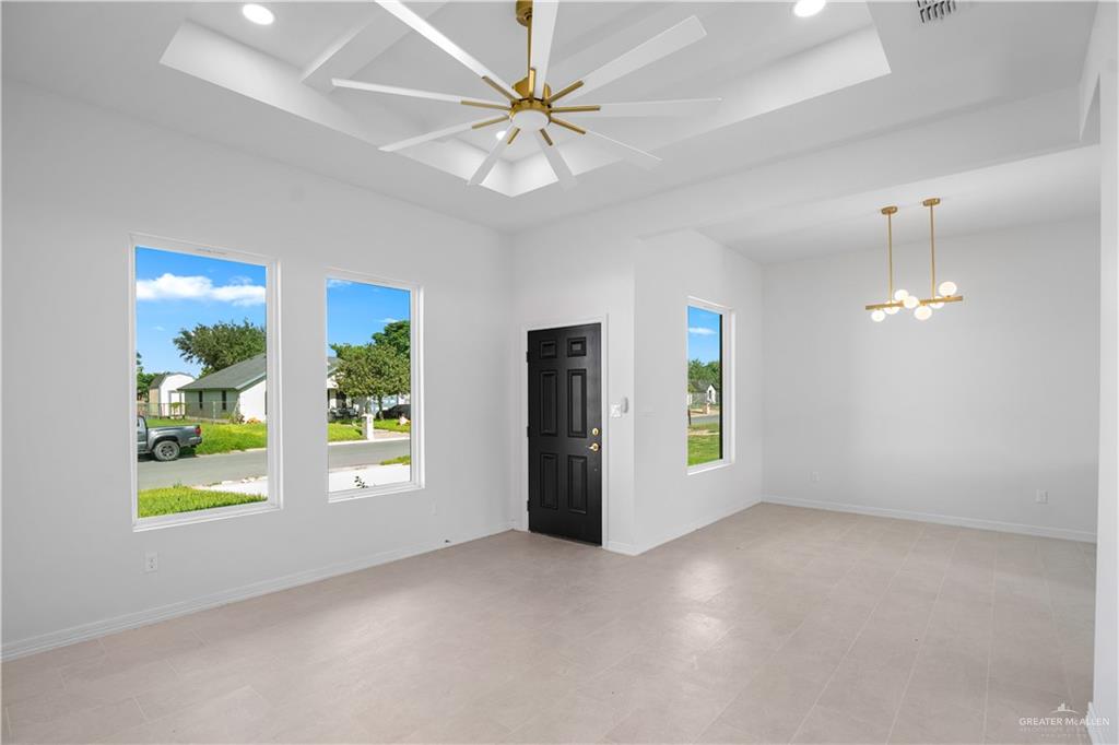 1005 Emerald Avenue Weslaco, TX 78599 - Photo 8 of 15 an empty room with windows and ceiling fan