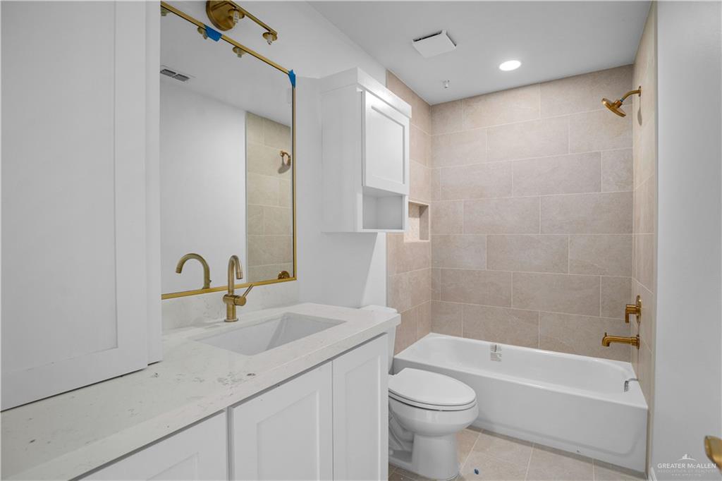 1005 Emerald Avenue Weslaco, TX 78599 - Photo 9 of 15 a bathroom with a sink a toilet and shower