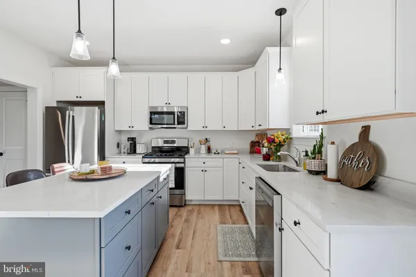 a kitchen with a sink a stove and cabinets