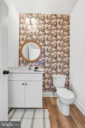 a bathroom with a granite countertop toilet and a sink