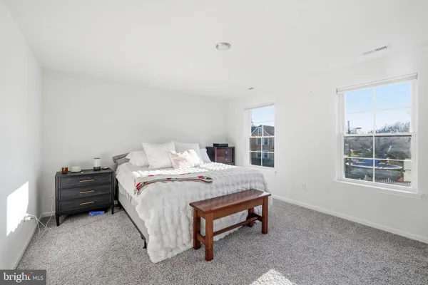 a bed sitting in a bedroom next to a window