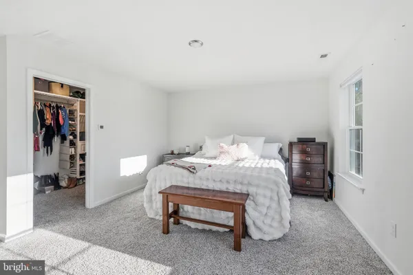 a bedroom with a bed and a walk in closet