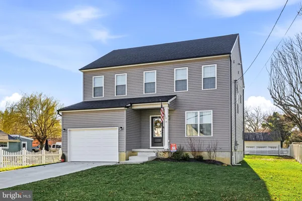 a front view of a house with a garden and yard