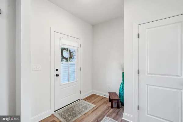 a view of room with hardwood floor and closet