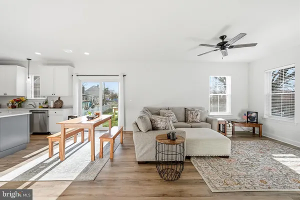 a living room with furniture rug and window
