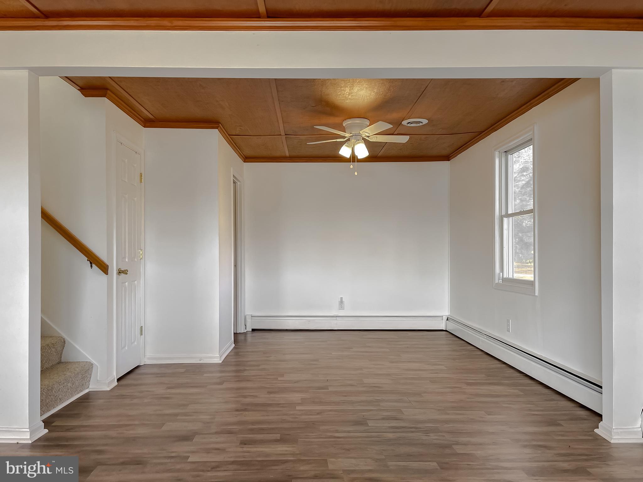 37117 Moore Road Bushwood, MD 20618 - Photo 15 of 45 a view of an empty room with wooden floor and a window