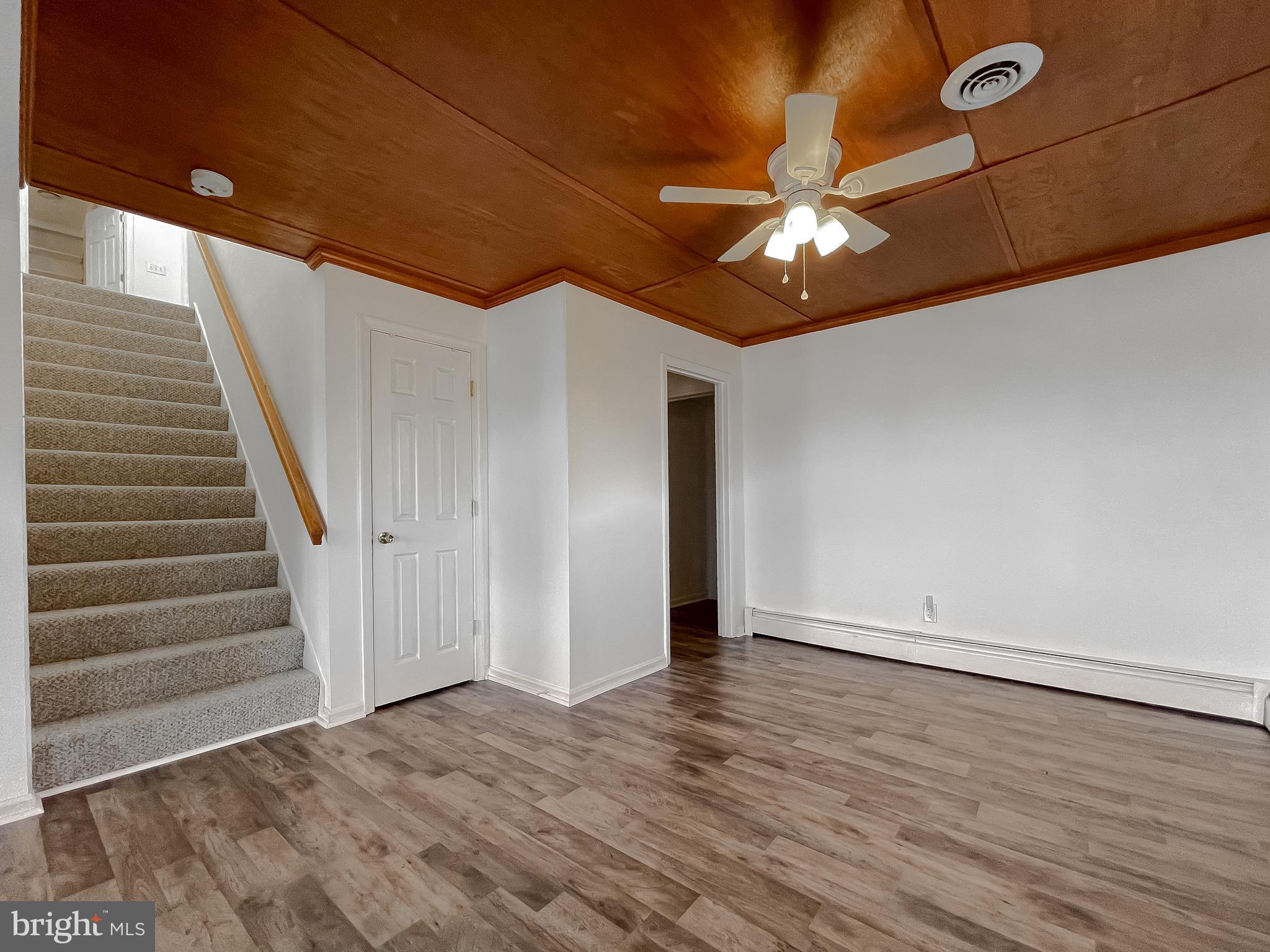 37117 Moore Road Bushwood, MD 20618 - Photo 16 of 45 a view of an empty room with wooden floor and a ceiling fan