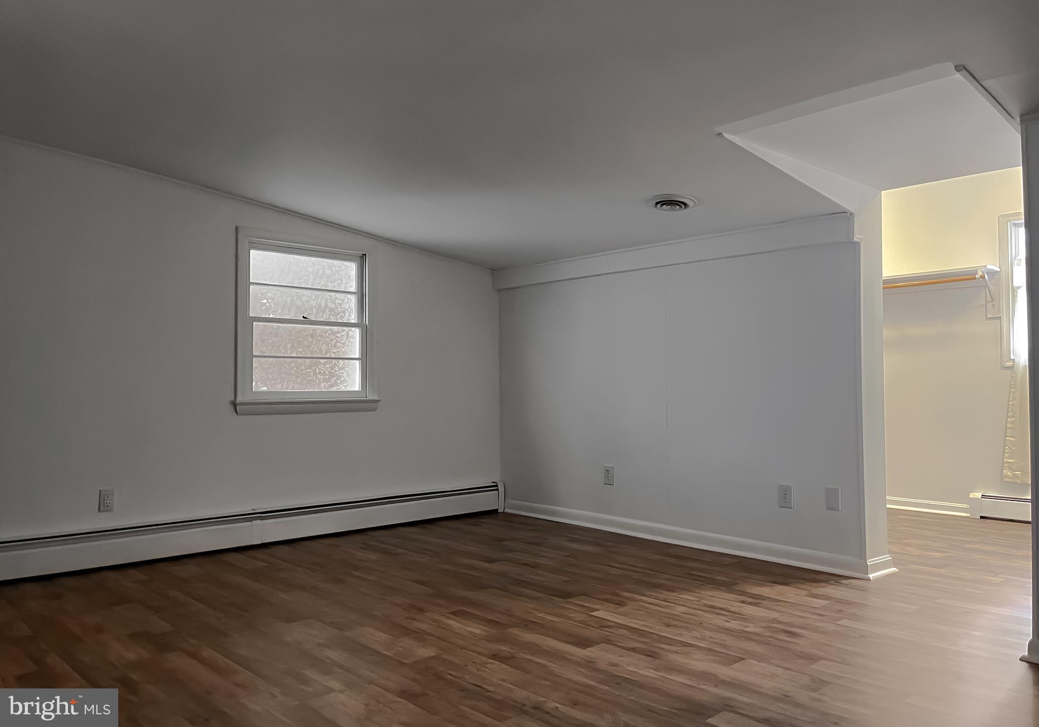 37117 Moore Road Bushwood, MD 20618 - Photo 18 of 45 an empty room with wooden floor and windows