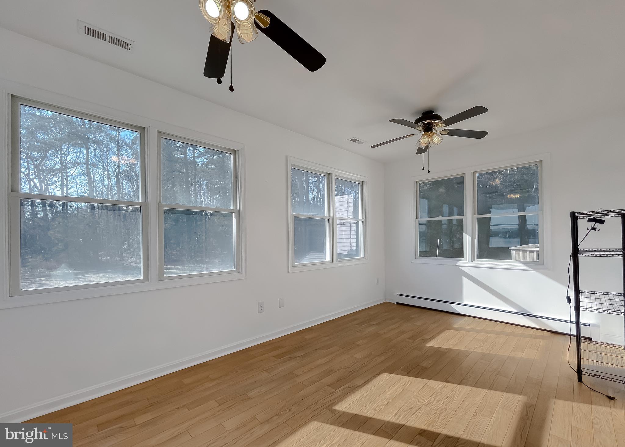 37117 Moore Road Bushwood, MD 20618 - Photo 32 of 45 a view of an empty room with a window and wooden floor