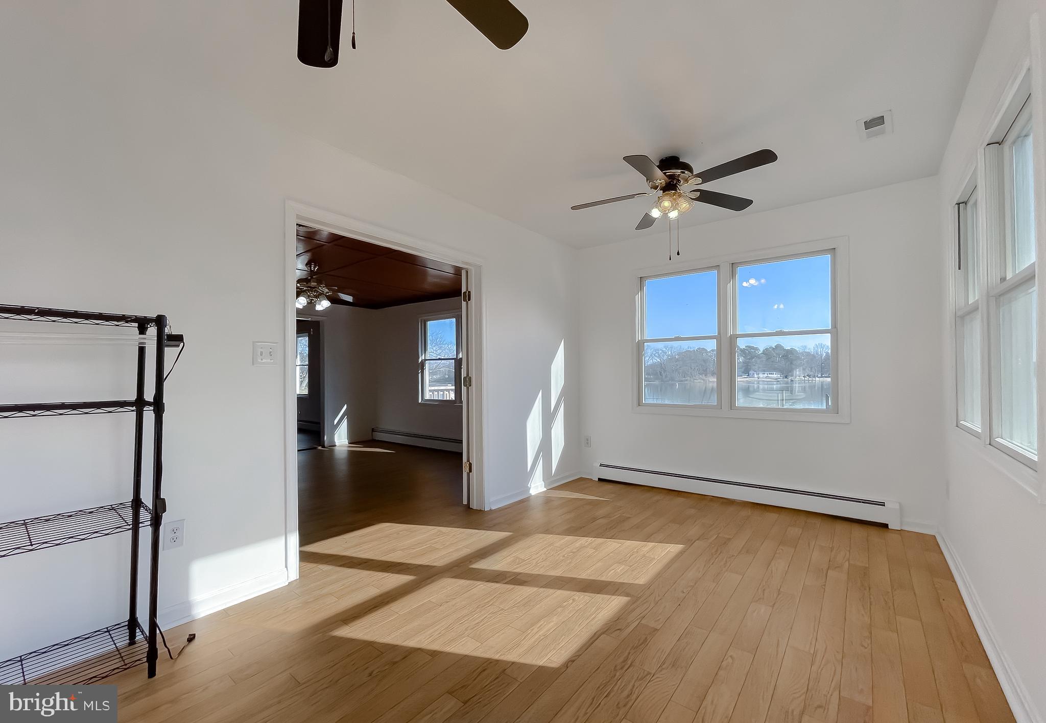 37117 Moore Road Bushwood, MD 20618 - Photo 34 of 45 a view of an empty room with a window and a ceiling fan