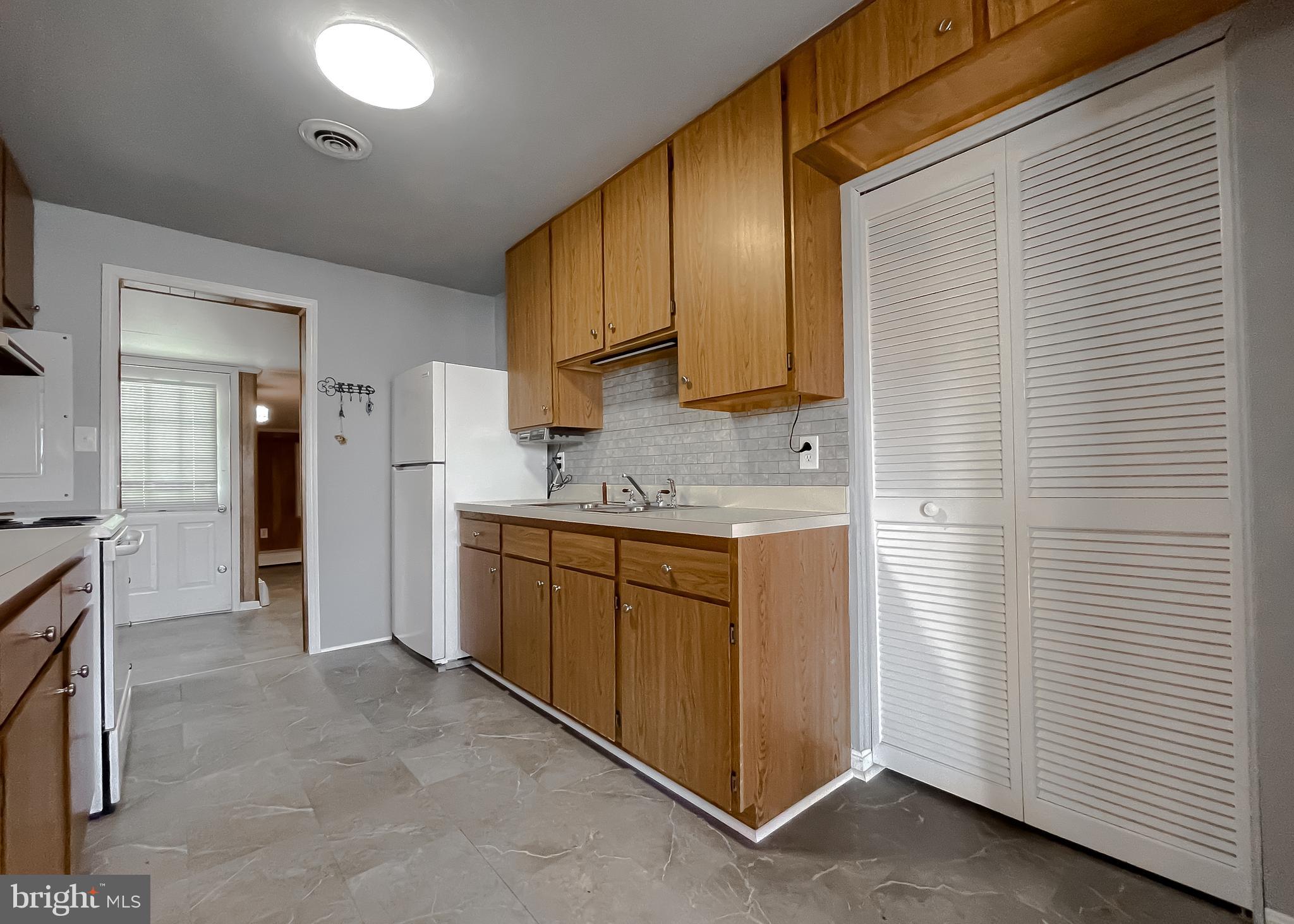 37117 Moore Road Bushwood, MD 20618 - Photo 38 of 45 a spacious bathroom with a granite countertop sink and a mirror