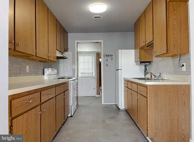 a kitchen with stainless steel appliances granite countertop a sink and cabinets