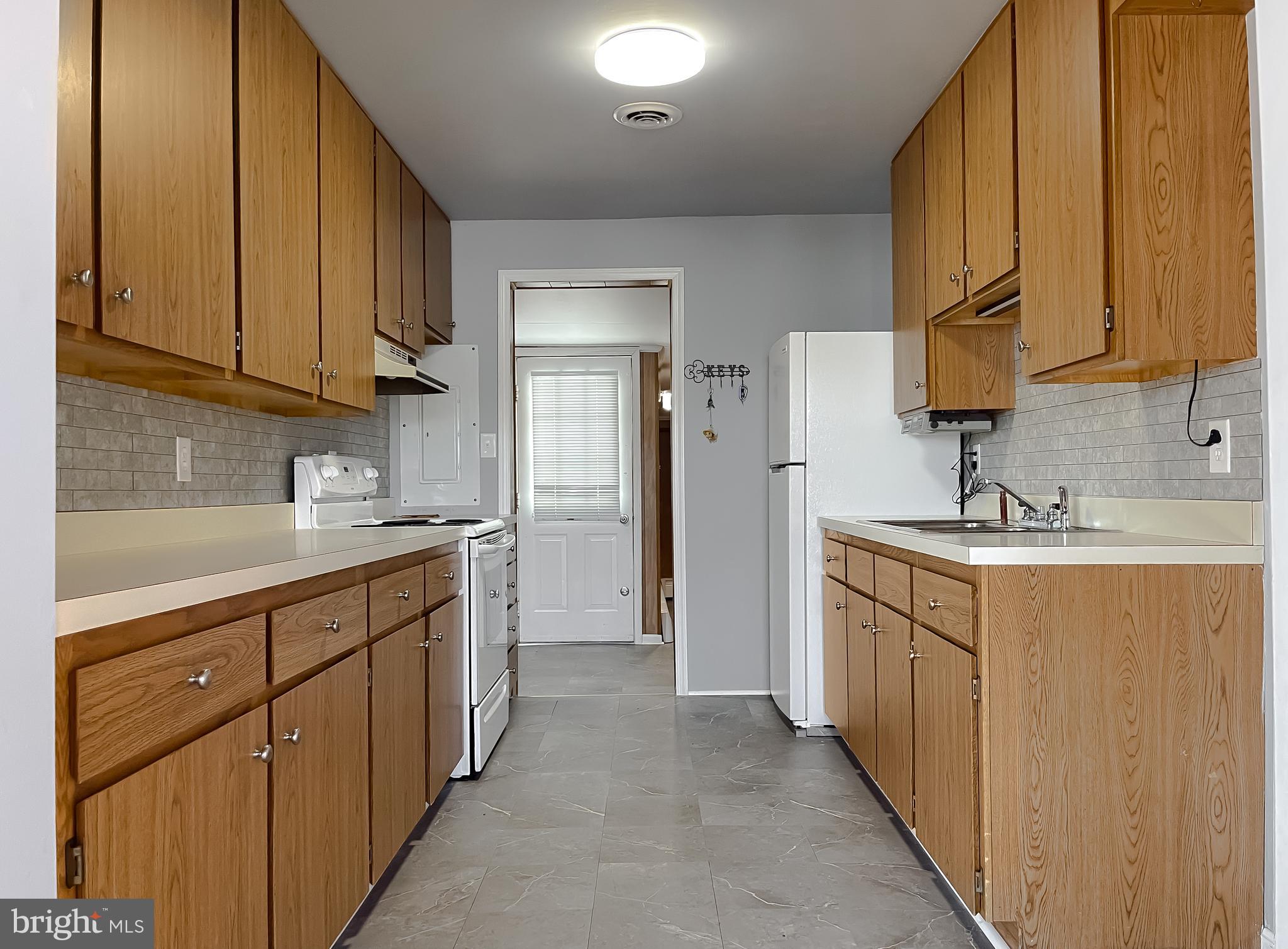 37117 Moore Road Bushwood, MD 20618 - Photo 40 of 45 a kitchen with cabinets stainless steel appliances a sink and a counter top space