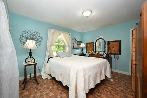 a bedroom with a bed and a lamp on table