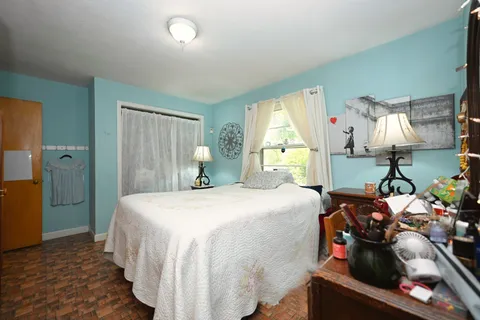 a bedroom with a bed and a lamp