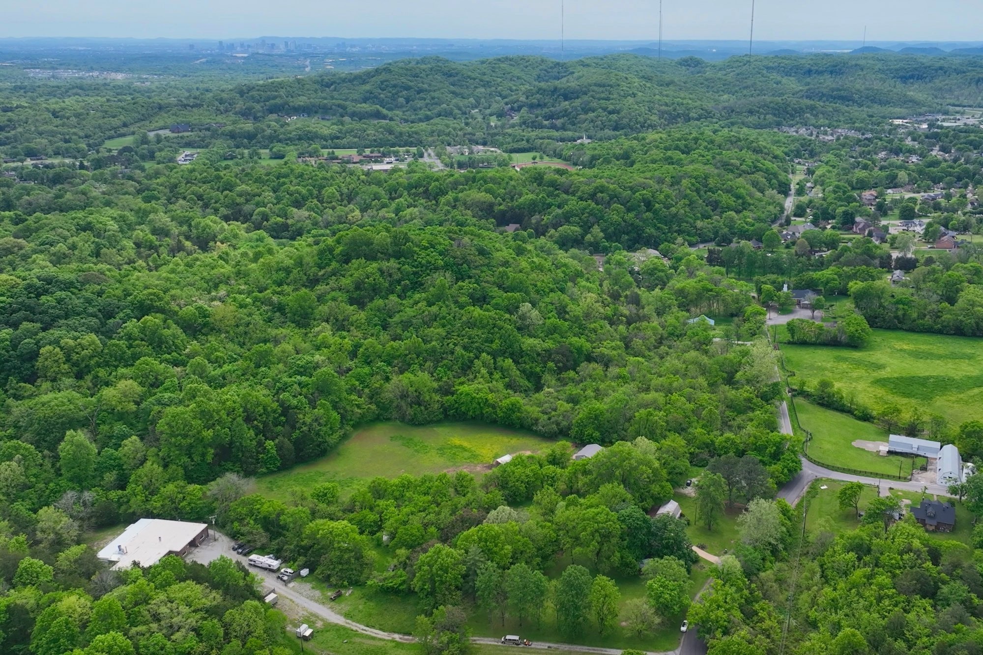4411 Jackson Road Whites Creek, TN 37189 - Photo 47 of 63 a view of a lush green forest with trees and some houses