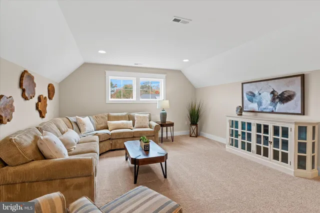 a living room with furniture a rug and a window