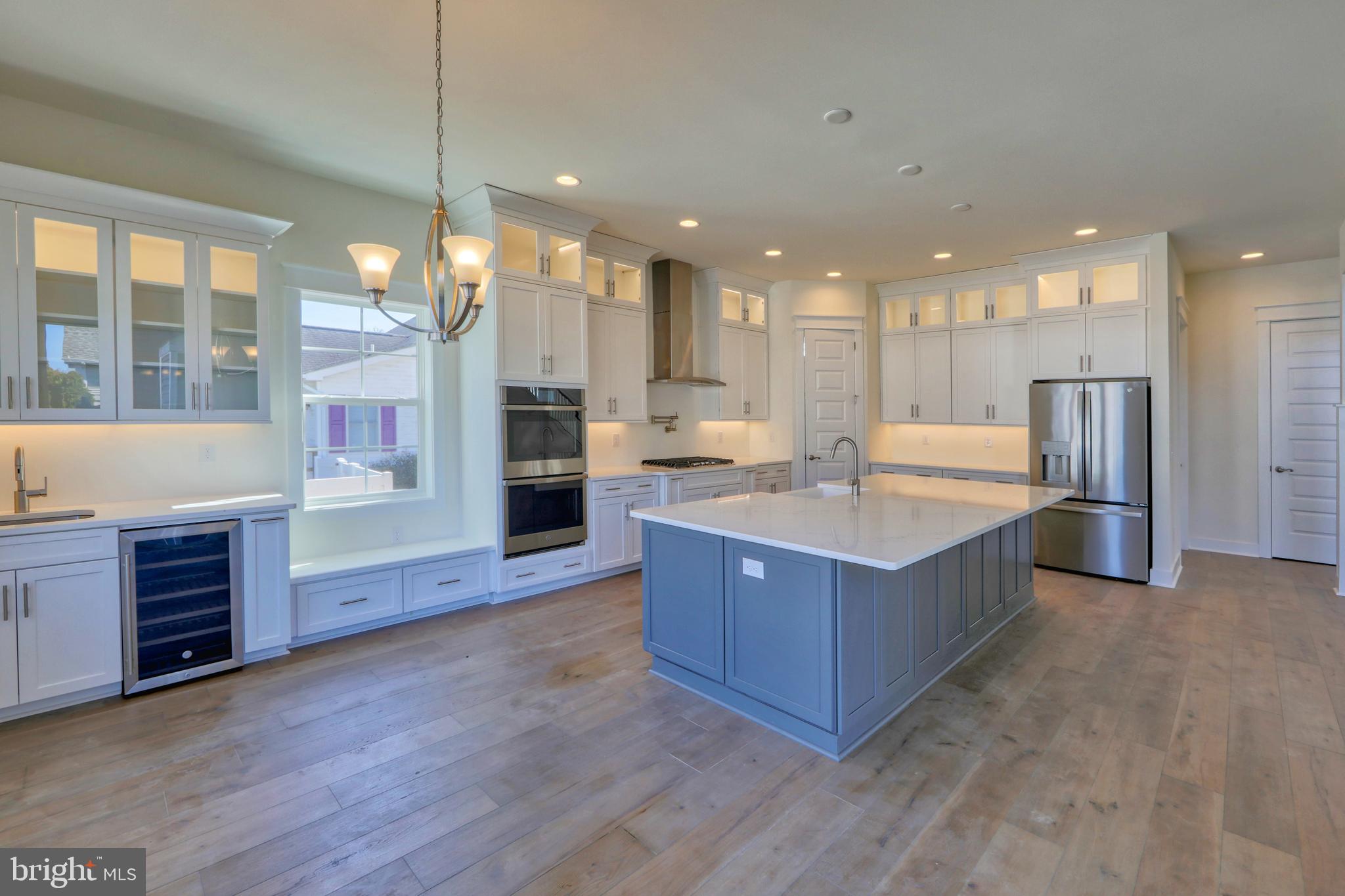 24105 Jerrico Road, Unit 26 Lincoln, DE 19960 - Photo 47 of 52 a large kitchen with stainless steel appliances granite countertop a large counter top and wooden floors