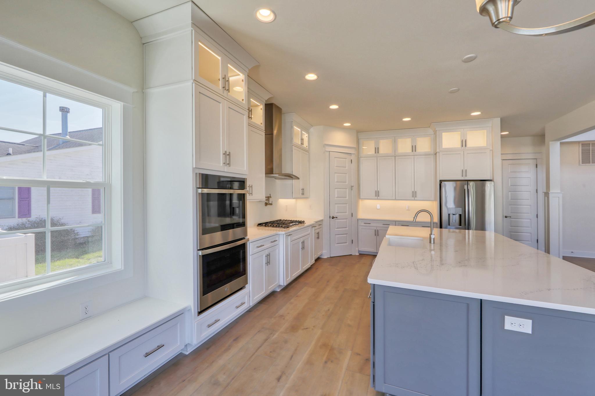 24105 Jerrico Road, Unit 26 Lincoln, DE 19960 - Photo 48 of 52 a large kitchen with stainless steel appliances kitchen island a large counter top and a sink