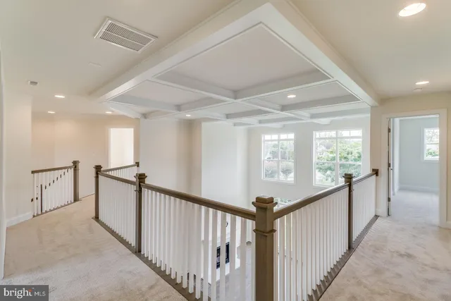 a large kitchen with stainless steel appliances a sink a stove and cabinets