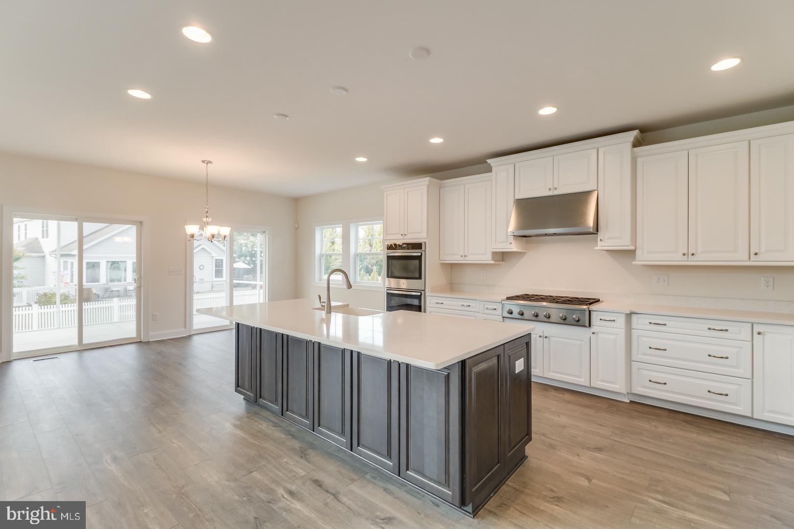 24105 Jerrico Road, Unit 26 Lincoln, DE 19960 - Photo 52 of 52 a large kitchen with stainless steel appliances a sink a stove and cabinets