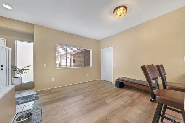 a view of room with workspace and wooden floor