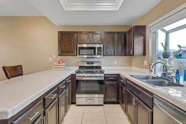 a kitchen with a sink stove and microwave