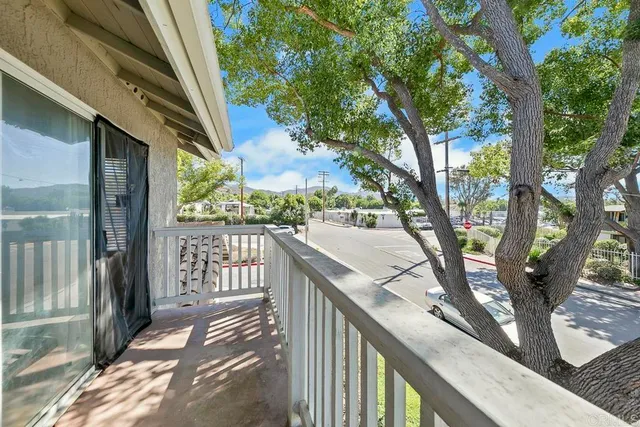 a view of balcony with wooden floor and fence