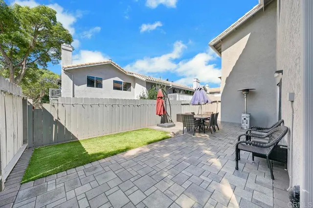 a view of a house with backyard and sitting area