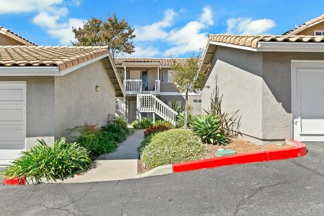 a view of a house with a yard and garage