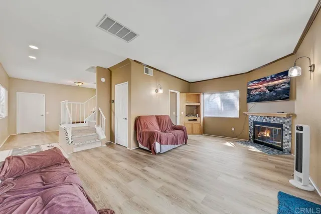 a spacious bedroom with a bed and a fireplace
