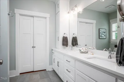 a bathroom with a double vanity sink and a mirror