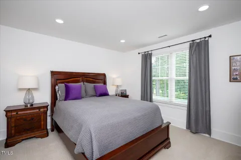 a bedroom with a bed and a lamp