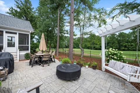 a view of a patio with couches chairs and a fire pit