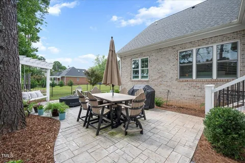 a view of a house with backyard and sitting area