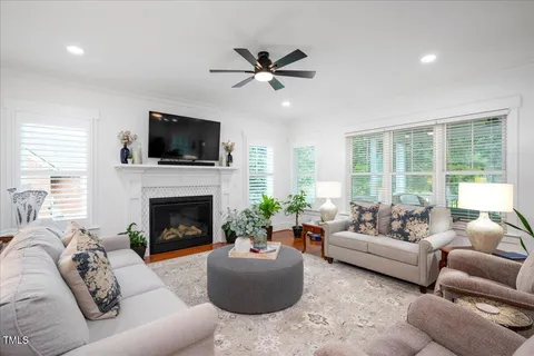 a living room with furniture a fireplace and a flat screen tv