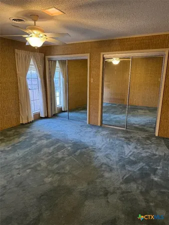 a view of an empty room with closet area
